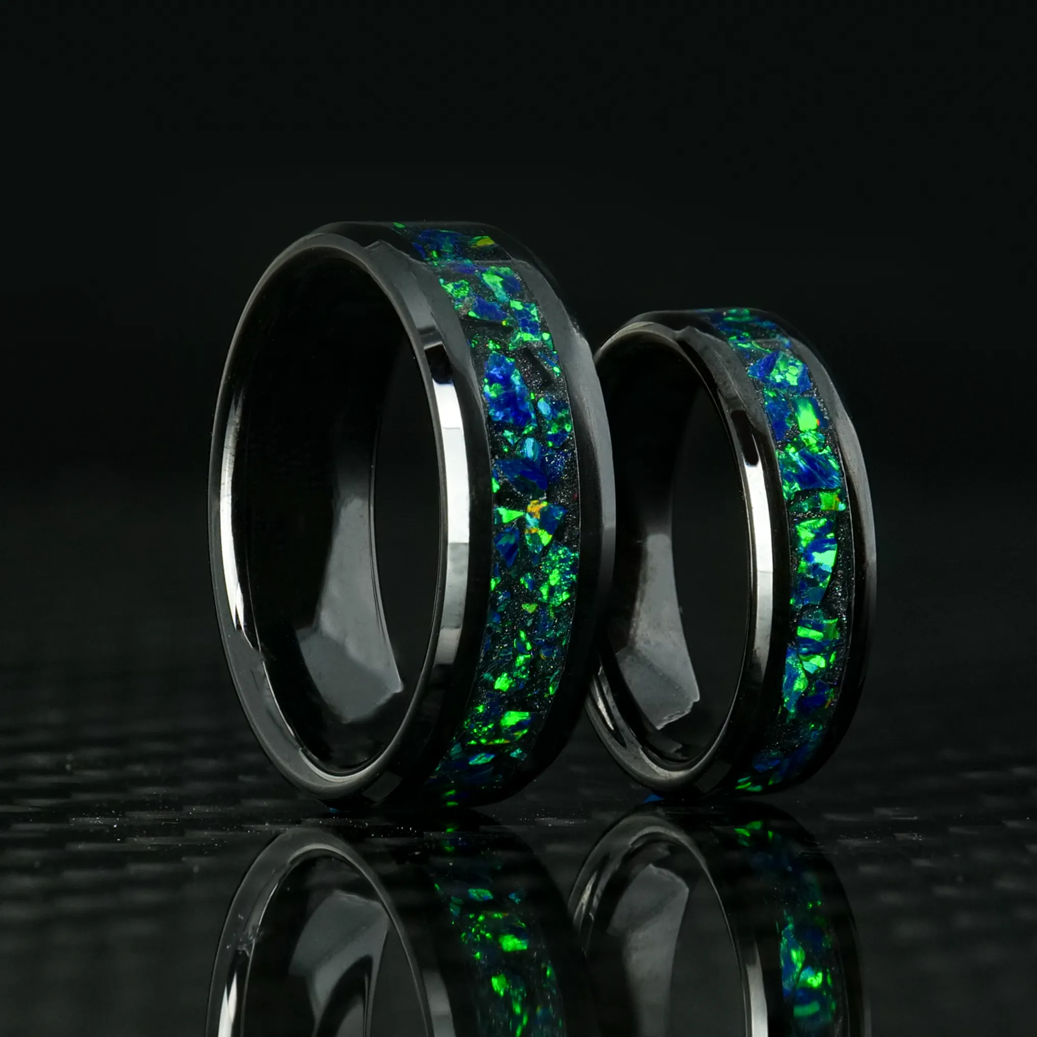 Matching Black Emerald Opal Glowstone Wedding Ring Set on Black Ceramic